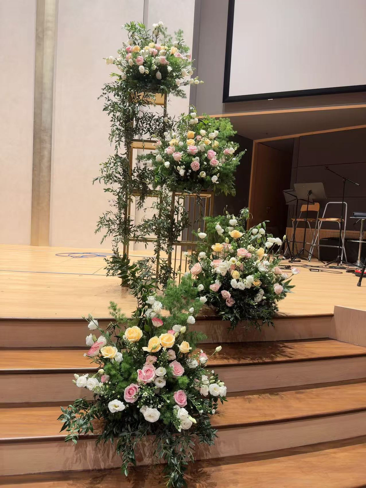 Detailed view of stair-step floral nests featuring peach and pink roses
