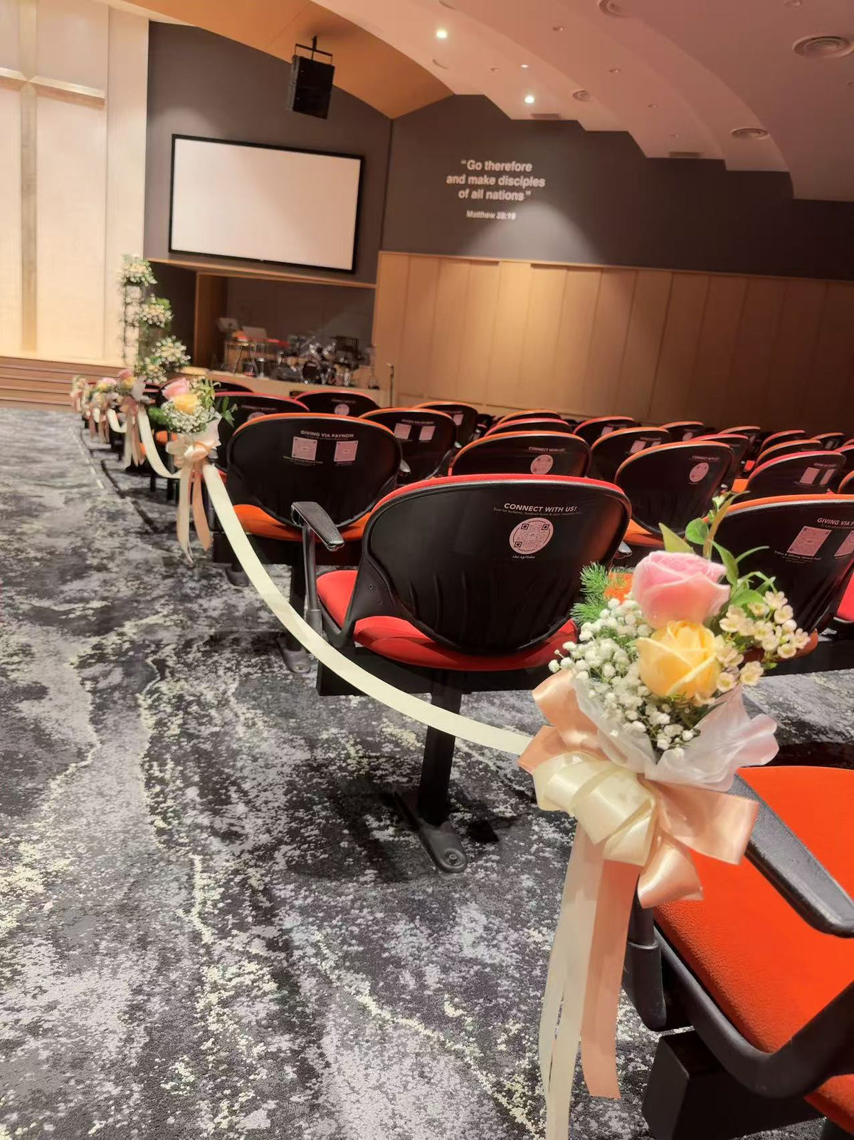 Perspective view along row chairs connected with cream ribbon lines